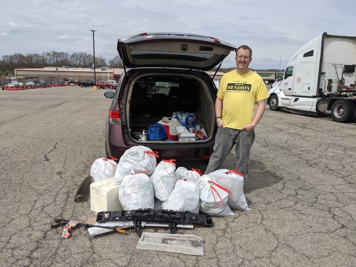 Joe Hendrix standing beside the collected trash and his van.